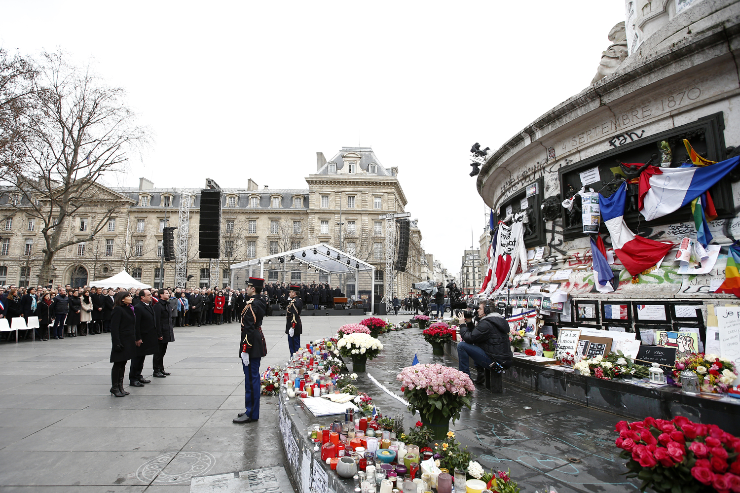 (From L) Mayor of Paris Anne Hidalgo, French President Francois Hollande and French Prime Minister Manuel Valls attend a remembrance rally at Place de la Republique (Republic square) on January 10, 2016 to mark a year since 1.6 million people thronged the French capital in a show of unity after attacks on the Charlie Hebdo newspaper and a Jewish supermarket. Just as it was last year, the vast Place de la Republique will be the focus of the gathering as people reiterate their support for freedom of expression and remember the other victims of what would become a year of jihadist outrages in France, culminating in the November 13 coordinated shootings and suicide bombings that killed 130 people and were claimed by the Islamic State (IS) group. / AFP / POOL / YOAN VALAT