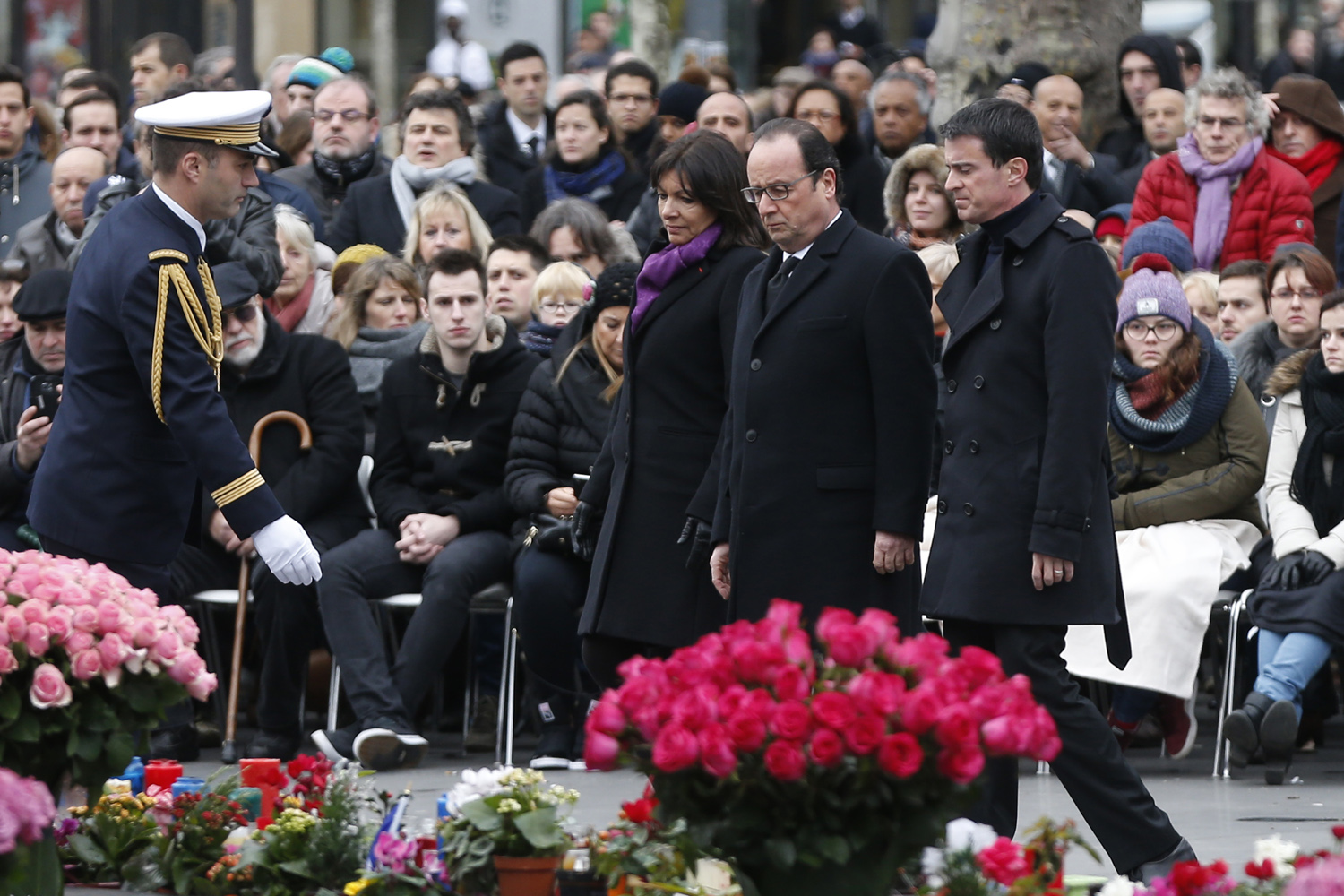 French Paris' mayor Anne Hidalgo (C), French President Francois Hollande (2ndR) and French Prime minister Manuel Valls (R) walk during a remembrance rally at Place de la Republique (Republic square) on January 10, 2016 in Paris, to mark a year since 1.6 million people thronged the French capital in a show of unity after attacks on the Charlie Hebdo newspaper and a Jewish supermarket. Just as it was last year, the vast Place de la Republique will be the focus of the gathering as people reiterate their support for freedom of expression and remember the other victims of what would become a year of jihadist outrages in France, culminating in the November 13 coordinated shootings and suicide bombings that killed 130 people and were claimed by the Islamic State (IS) group. AFP PHOTO / THOMAS SAMSON / AFP / THOMAS SAMSON