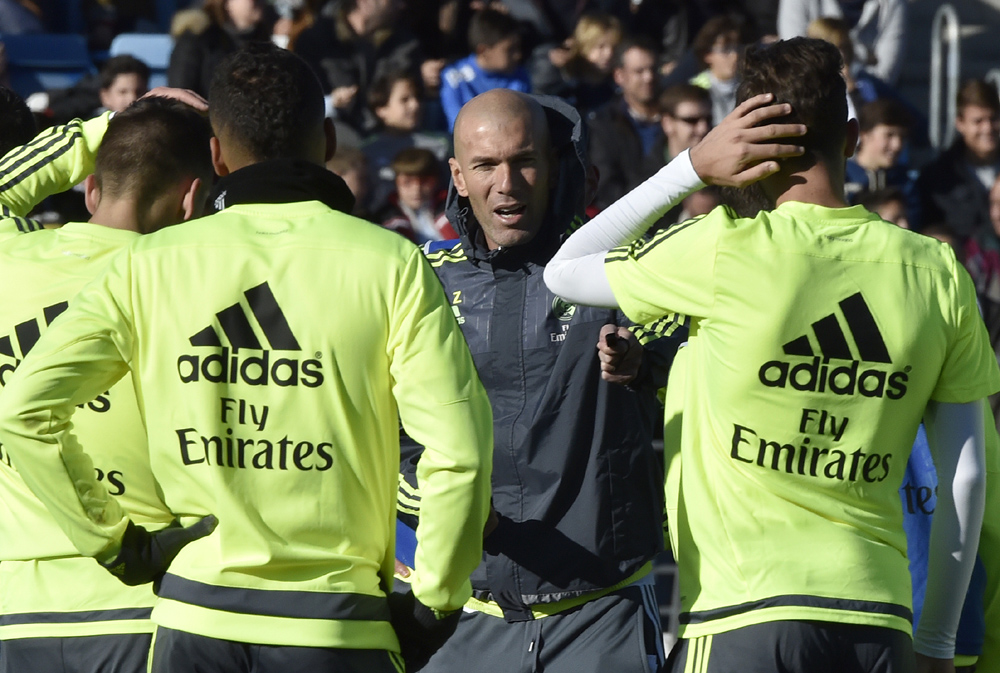Real Madrid's new French coach Zinedine Zidane (C) gives instructions to his players during his first training session as coach of Real Madrid at the Alfredo di Stefano stadium in Valdebebas, on the outskirts of Madrid, on January 5, 2016. Real Madrid legend Zinedine Zidane promised to put his "heart and soul" into managing the Spanish giants after he was sensationally named as coach following Rafael Benitez's unceremonious sacking. AFP PHOTO/ GERARD JULIEN / AFP / GERARD JULIEN