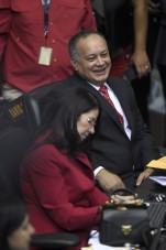 Diosdado Cabello (back), outgoing president of the National Assembly and Venezuela's first lady, Cilia Flores talk at the parliament in Caracas, on January 5, 2016. Venezuela's President Nicolas Maduro ordered the security forces to ensure the swearing-in of a new opposition-dominated legislature passes off peacefully Tuesday, after calls for rallies raised fears of unrest. AFP PHOTO/JUAN BARRETO / AFP / JUAN BARRETO