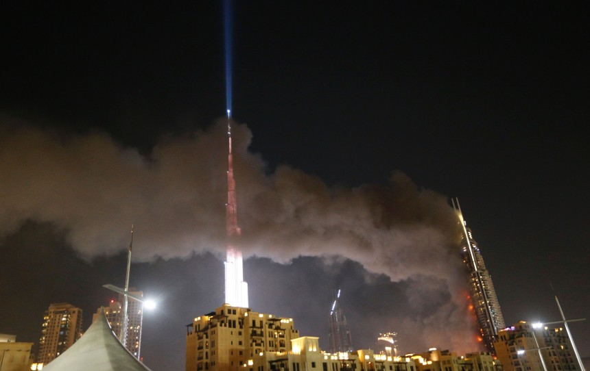 A picture taken on December 31, 2015 the Address Downtown hotel burning after huge fire ripped through the luxury hotel near the world's tallest tower, in Dubai. People were gathering to watch New Year's Eve celebrations when the hotel caught on fire without causing casualties, according to authorities. AFP PHOTO / KARIM SAHIB / AFP / KARIM SAHIB (Photo credit should read KARIM SAHIB/AFP/Getty Images)