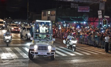 Pope Francis waves from the Popemobile upon his arrival in Mexico City on February 12, 2016. Catholic faithful flocked to the streets of Mexico City to greet Pope Francis on Friday after the pontiff held a historic meeting with the head of the Russian Orthodox Church in Cuba. AFP PHOTO/Yuri Cortez / AFP / YURI CORTEZ