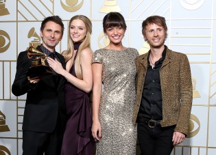 LOS ANGELES, CA - FEBRUARY 15: Recording artists Matt Bellamy (L) and Dominic Howard of music group Muse, winners of Best Rock Album for 'Drones,' models Rayana Ragan and Elle Evans pose in the press room during The 58th GRAMMY Awards at Staples Center on February 15, 2016 in Los Angeles, California. Frederick M. Brown/Getty Images for NARAS/AFP