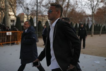 FC Barcelona's Neymar leaves the national court after testifying at an investigation into alleged irregularities regarding his transfer to Barcelona, in Madrid, Tuesday, Feb. 2, 2016. The court is looking into a complaint made by a Brazilian investment group which claims it was financially harmed when Barcelona and Neymar allegedly withheld the real amount of the player's transfer fee from Brazilian club Santos in 2013. (AP Photo/Francisco Seco)