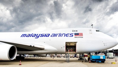 A plane carrying coffins with the remains of victims of Malaysian Airlines flight MH17 sits on the tarmac at Schiphol International Airport in Amsterdam before flying to Malaysia on August 21, 2014. Malaysia will drape itself in black for a national day of mourning on August 22 as it welcomes home the first remains of its 43 citizens killed in the MH17 disaster. The MH17 plane was shot down over rebel-held eastern Ukraine on July 17 en route from Amsterdam to Kuala Lumpur, with the west blaming Russian-backed separatists, while Moscow blames Ukraine. AFP PHOTO / ANP / KOEN VAN WEEL == NETHERLANDS OUT ==