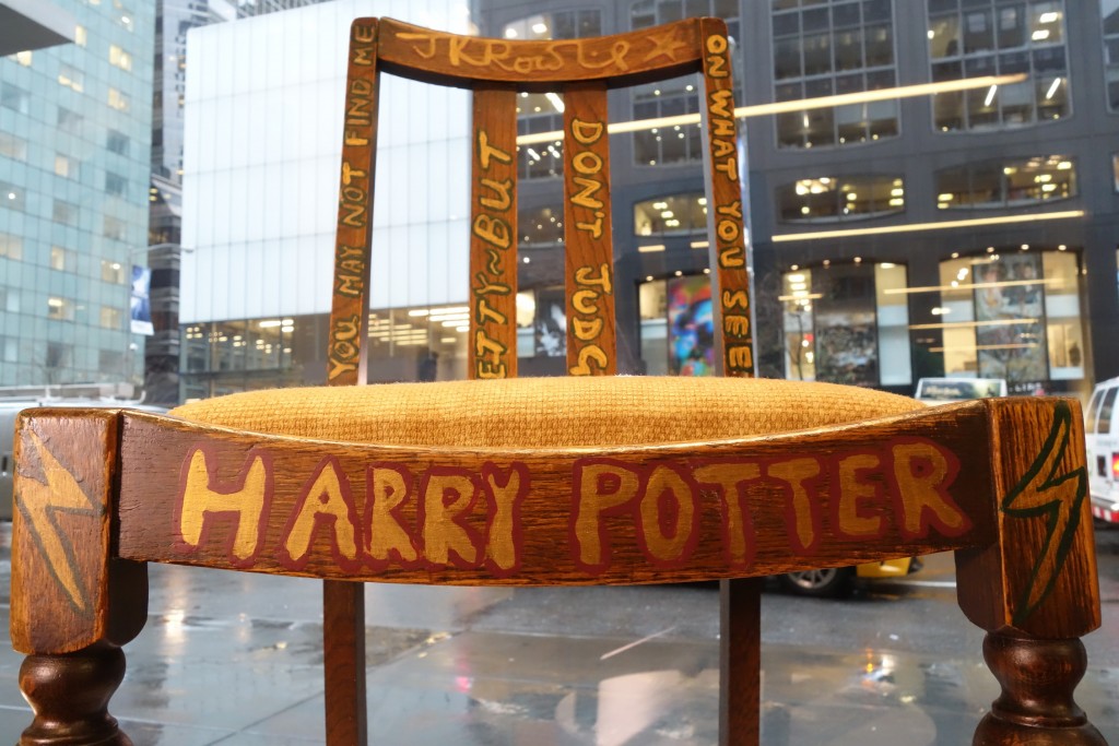 A chair used, and later decorated, by author J.K. Rowling while she wrote the first two Harry Potter books on display alongside a letter of provenance from the author at Heritage Auctions in New York on April 4 2016 ahead of its sale on April 6.                                 / AFP / William EDWARDS