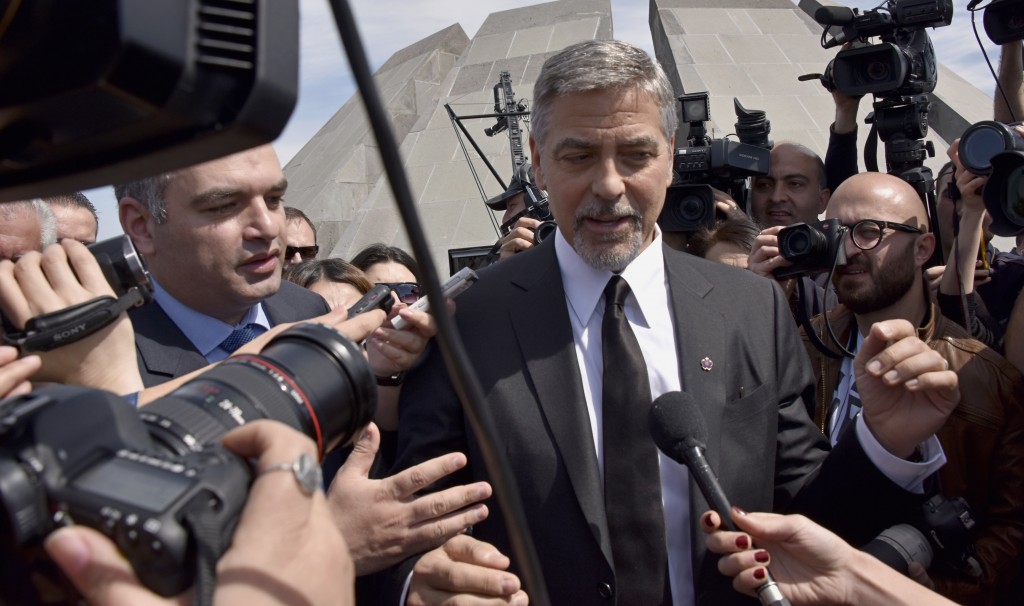 US actor George Clooney talks to media in Yerevan at the Genocide Memorial on April 24, 2016. Hollywood star and rights advocate George Clooney led thousands of Armenians on a march to a hilltop memorial in Yerevan to commemorate the 101st anniversary of the WW I-era Armenian genocide in the Ottoman Empire. / AFP PHOTO / KAREN MINASYAN