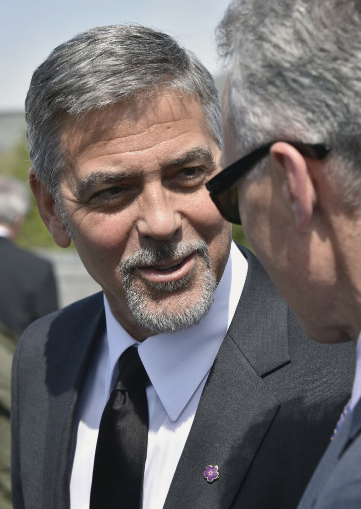 US actor George Clooney attends a ceremony at the Armenian Genocide Memorial in Yerevan on April 24, 2016. Hollywood star and rights advocate George Clooney led thousands of Armenians on a march to a hilltop memorial in Yerevan to commemorate the 101st anniversary of the WW I-era Armenian genocide in the Ottoman Empire. / AFP PHOTO / KAREN MINASYAN