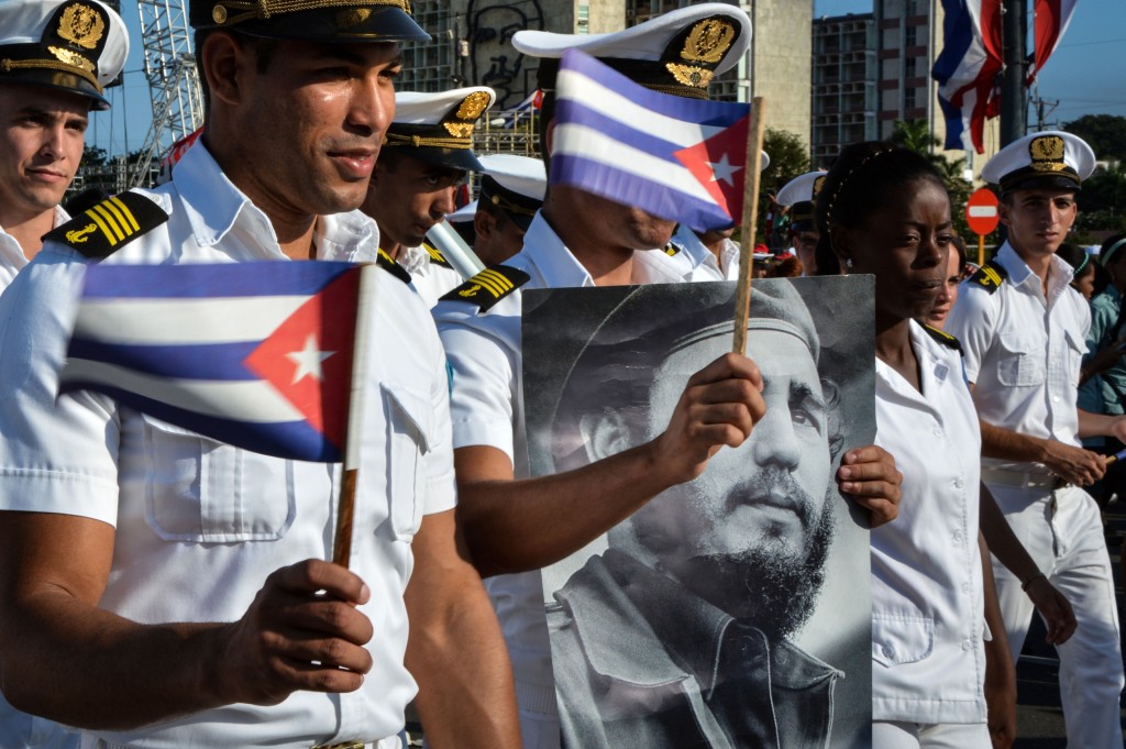 Members of the Navy display a picture of Cuban former president Fidel Castro during the May Day parade at Revolution Square in Havana, on May 1, 2016. / AFP PHOTO / JORGE BELTRAN
