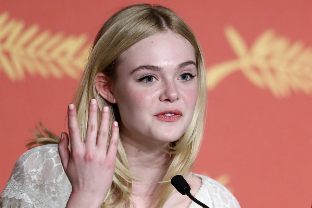 US actress Elle Fanning talks on May 20, 2016 during a press conference for the film "The Neon Demon" at the 69th Cannes Film Festival in Cannes, southern France. / AFP PHOTO / Laurent EMMANUEL