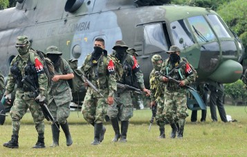 Demobilized members of the ELN (National Liberation Army) arrive in Cali, Colombia on July 16, 2013. Thirty members of the ELN surrendered with their weapons. AFP PHOTO/STR