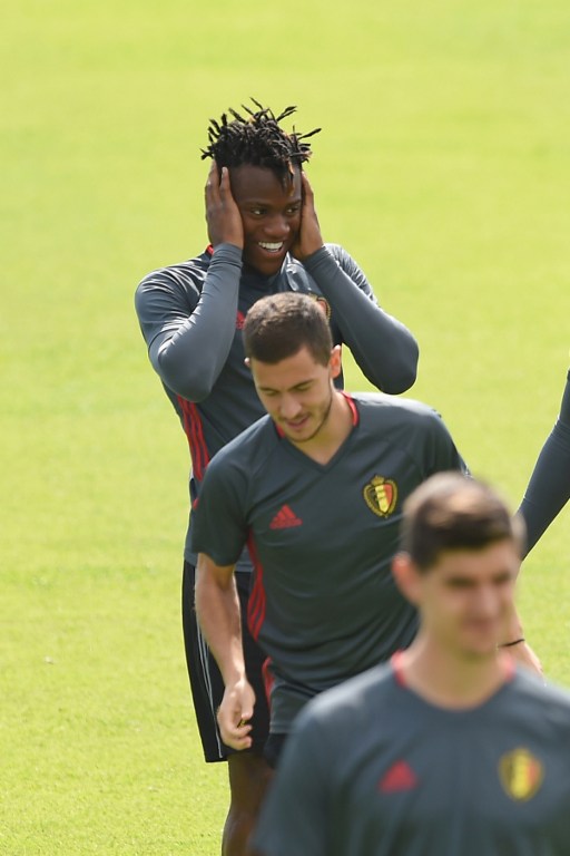 Belgium's forward Michy Batshuayi (Top) jokes with team mate Eden Hazard (C) during a training session during the Euro 2016 football tournament at Le Haillan on June 30, 2016.  / AFP PHOTO / NICOLAS TUCAT