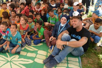 On 2 June 2016, UNICEF goodwill ambassador Ricky Martin watches a puppet show about good hygiene practices with Syrian refugee children from the Rmoul informal settlement in northern Lebanon. Around 139 refugees live in the Rmoul settlement, more than half of them children under 18. UNICEF, with its partners, provides a comprehensive package of water, sanitation and hygiene promotion package for Rmoul and more than 1,360 other locations. Including the provision of adequate water supplies, latrines, and hygiene promotion activities.  World-renowned singer and UNICEF Goodwill Ambassador Ricky Martin calls for increased focus on safeguarding the futures of millions of children affected by the Syria conflict, whose lives have been shaped by displacement, violence and a persistent lack of opportunities. Around 1.1 million Syrians have sought refuge in Lebanon since the start of the crisis in 2011, more than half of them are children. Child refugees are particularly at risk of exploitation and abuse, with large numbers being left with no choice but to go out to work, rather than attend school.  The deteriorating economic situation for Syrian refugees has dramatically exacerbated the problem of child labour in Lebanon. Adding to the psychological distress already affecting many of the children who have fled conflict and violence at home is the challenge associated with some of the worst forms child labour such as working on construction sites, which can cause long-term developmental and psychological damage as well as physical harm.  During the two-day visit on 1-2 June 2016, Martin also witnessed how UNICEF is working to provide protective environments for children and adolescents where they can play and receive the support they need to get back into formal education. In Lebanons Bekaa valley and Akkar, Martin participated in recreational activities for children at safe spaces in informal settlements. Additionally, he met adolescents attending life-skills training, prov