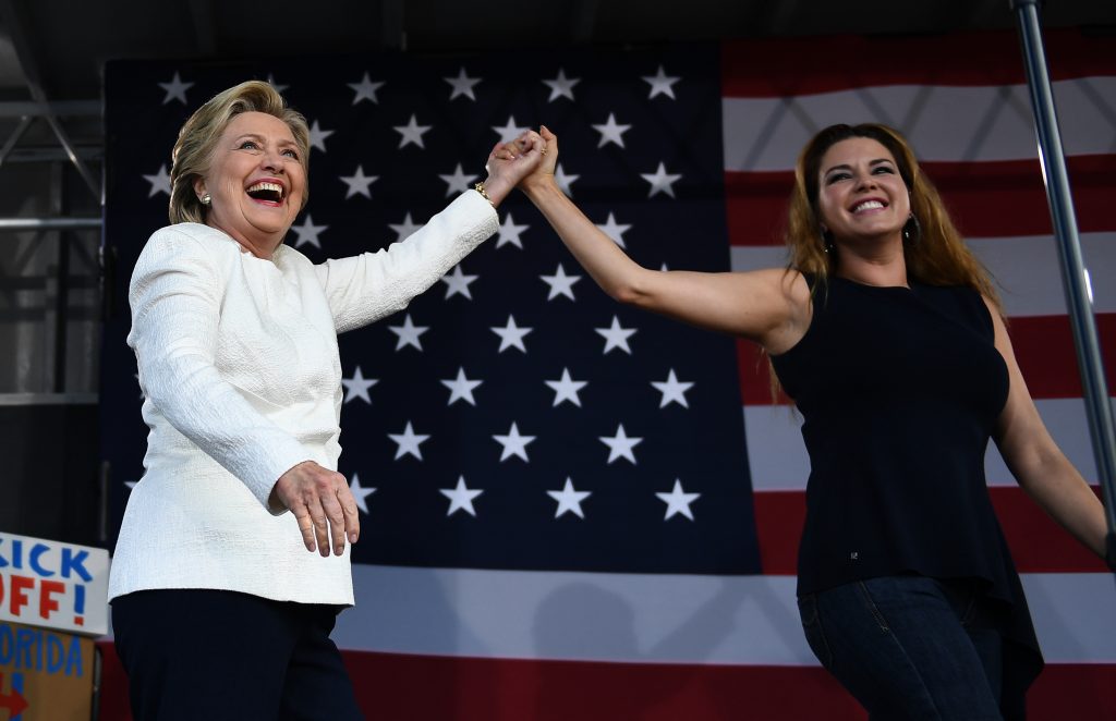US Democratic presidential nominee Hillary Clinton and former Miss Universe Alicia Machado wave during a campaign rally at the Pasco-Hernando State College in Dade City, Florida, on November 1, 2016. FBI agents are plumbing hundreds of thousands of emails in search of potentially incriminating evidence against Democratic nominee Hillary Clinton, in a high pressure probe seven days before the US presidential election. What will come out of it and when is not known, but the impact of the FBI's bombshell discovery of a new trove of Clinton emails is already reverberating in the neck-and-neck race for the White House. / AFP PHOTO / JEWEL SAMAD