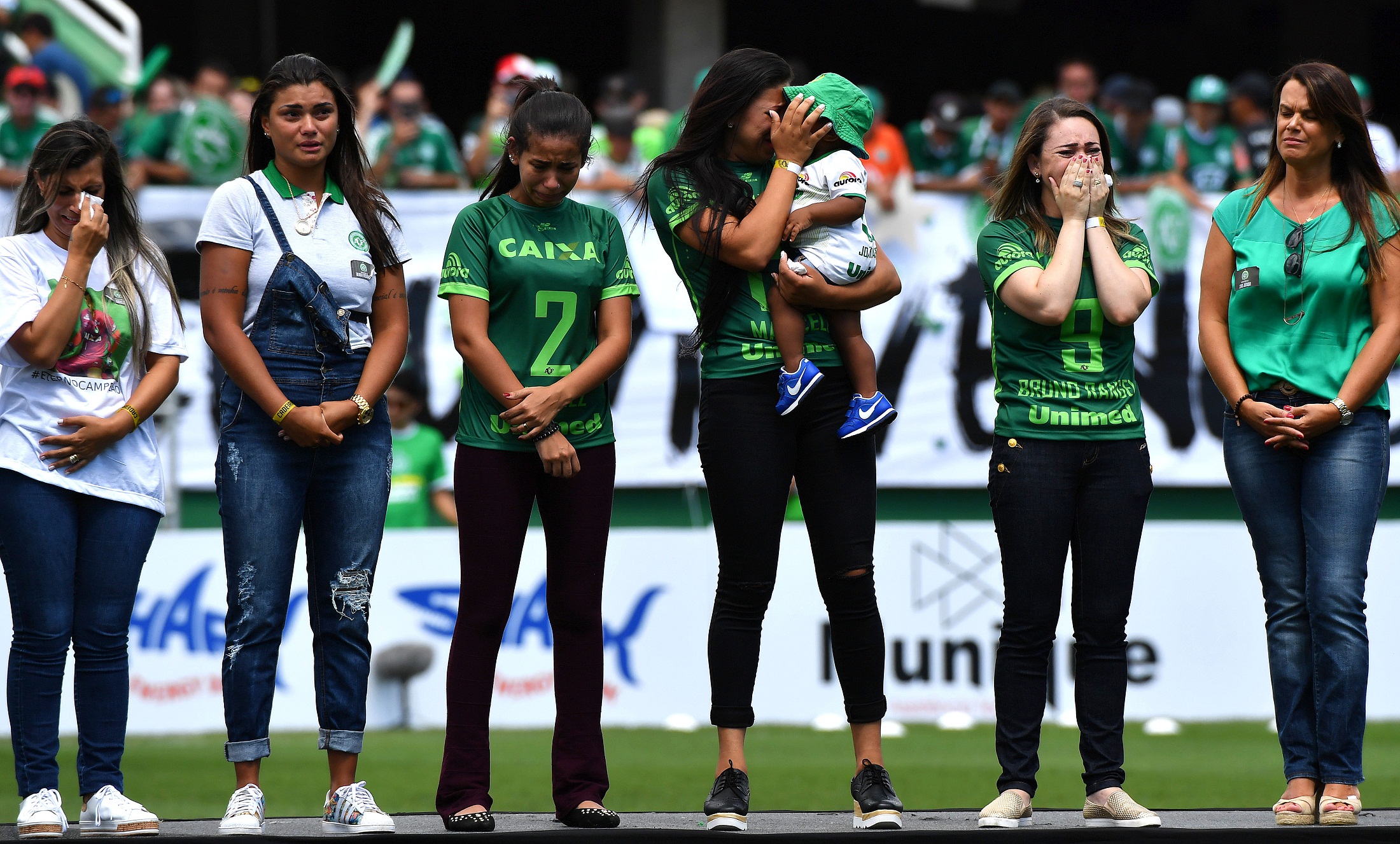 Relatives of players who died in the LaMia airplane crash in Colombia are seen at the Arena Conda stadium in Chapeco, Santa Catarina state, in southern Brazil on January 21, 2017, before a friendly match against Palmeiras - Brazilian Champion 2016.  Most of the members of the Chapocoense football team perished in a November 28, 2016 plane crash in Colombia. / AFP PHOTO / NELSON ALMEIDA