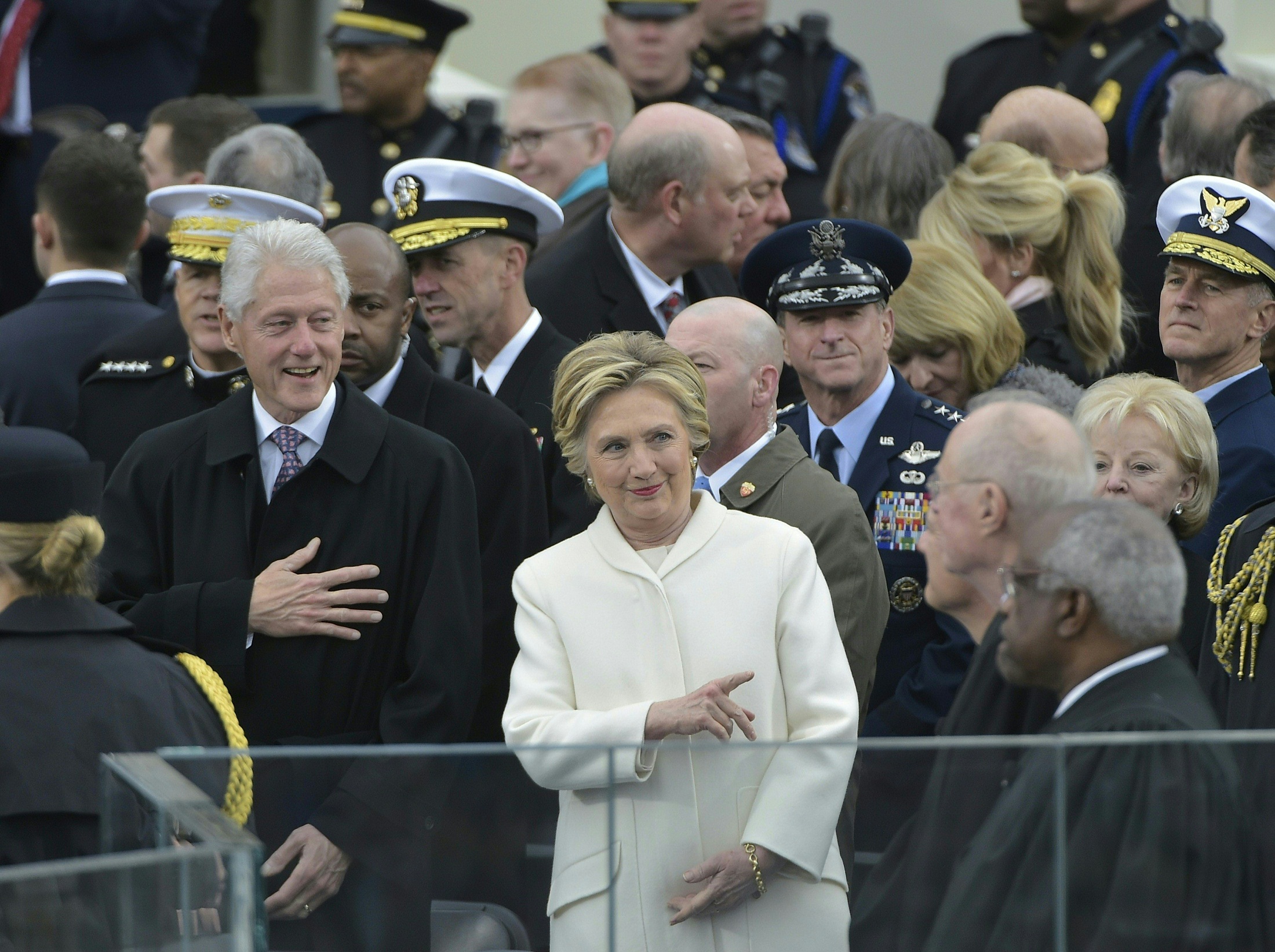 Former Democratic presidential candidate Hillary Clinton and former president Bill Clinton are seen amidst guests on the platform at the US Capitol in Washington, DC, on January 20, 2017, before the swearing-in ceremony of US President-elect Donald Trump. / AFP PHOTO / Mandel NGAN