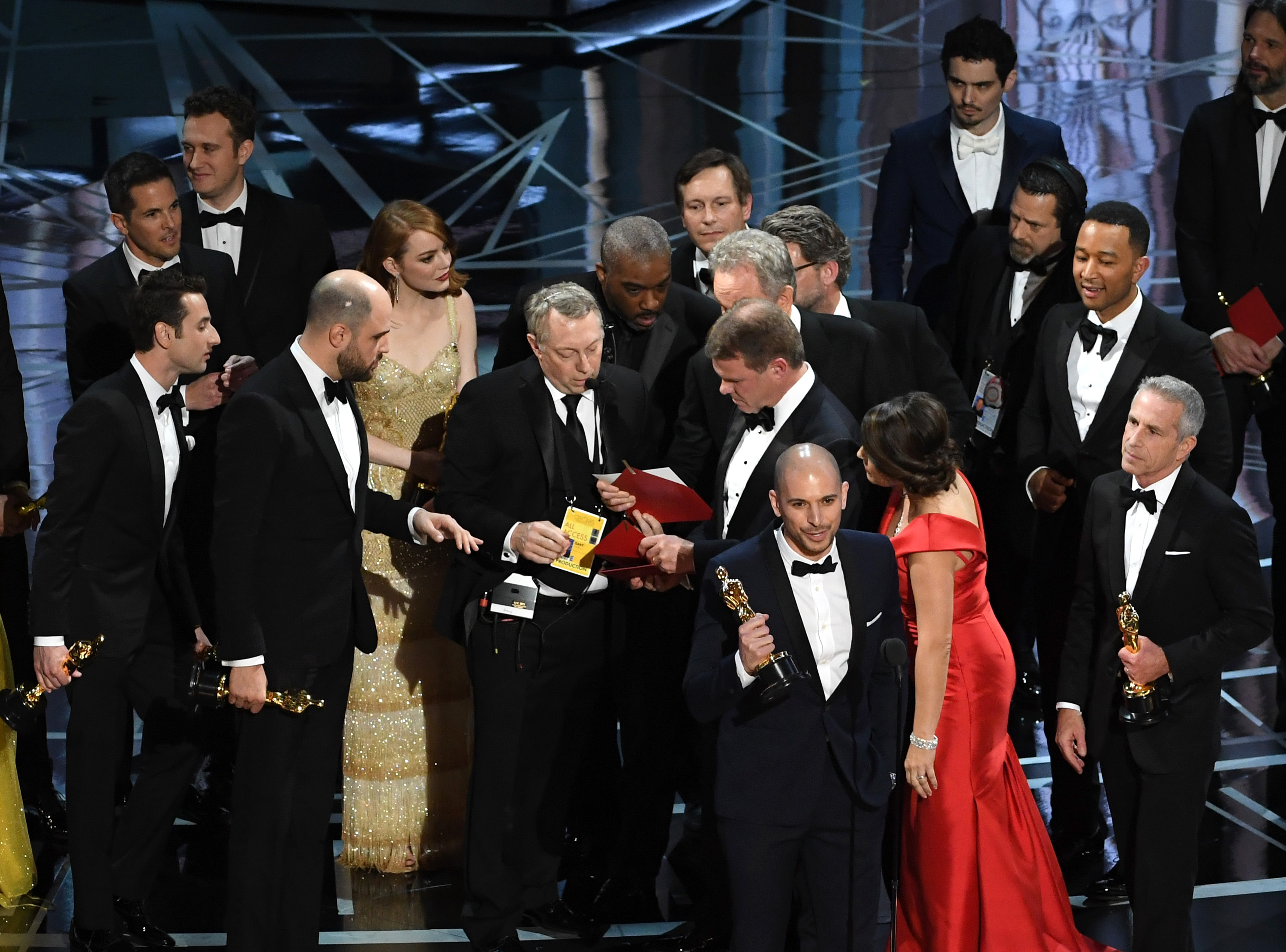 HOLLYWOOD, CA - FEBRUARY 26: 'La La Land' producer Fred Berger (R) speaks at the microphone as production staff consult behind him regarding a presentation error of the Best Picture award (later awarded to 'Moonlight') onstage during the 89th Annual Academy Awards at Hollywood & Highland Center on February 26, 2017 in Hollywood, California. Kevin Winter/Getty Images/AFP